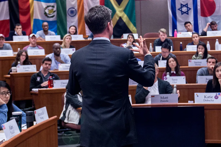 A faculty member teaching an MBA class in Aldrich Hall.