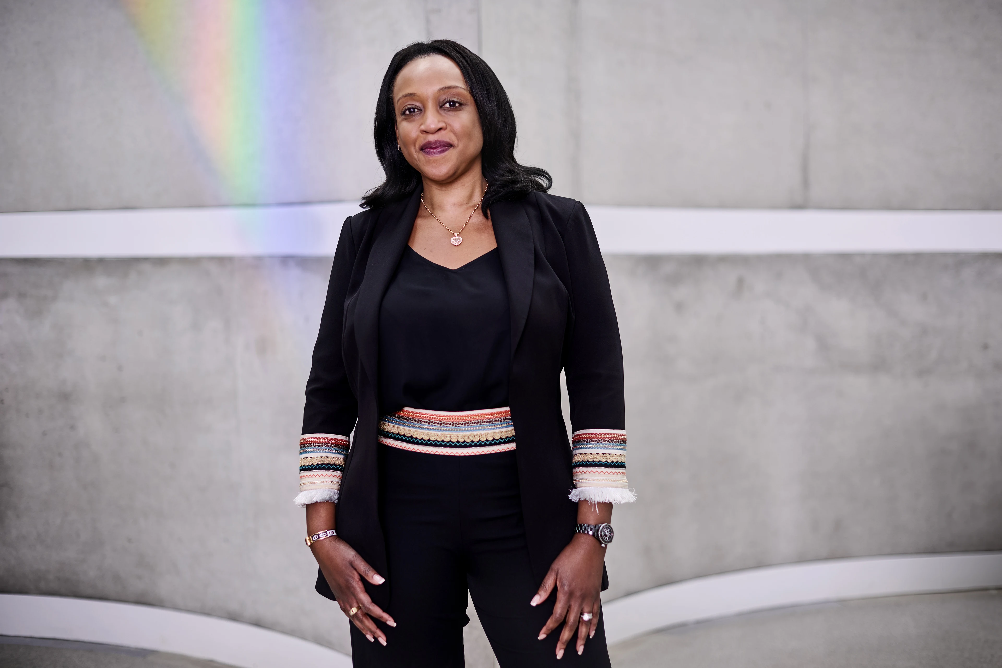 Portrait of AMP Massy Williams Executive Education participant wearing a black suit with colorful detail