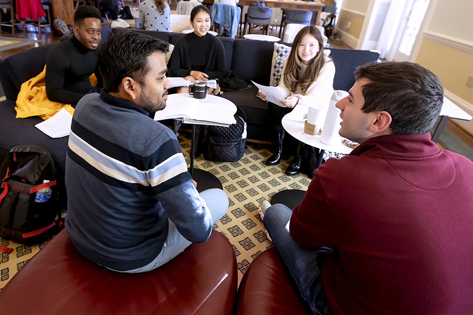 A group of MBA students prepares for a case discussion together in Spangler Center.