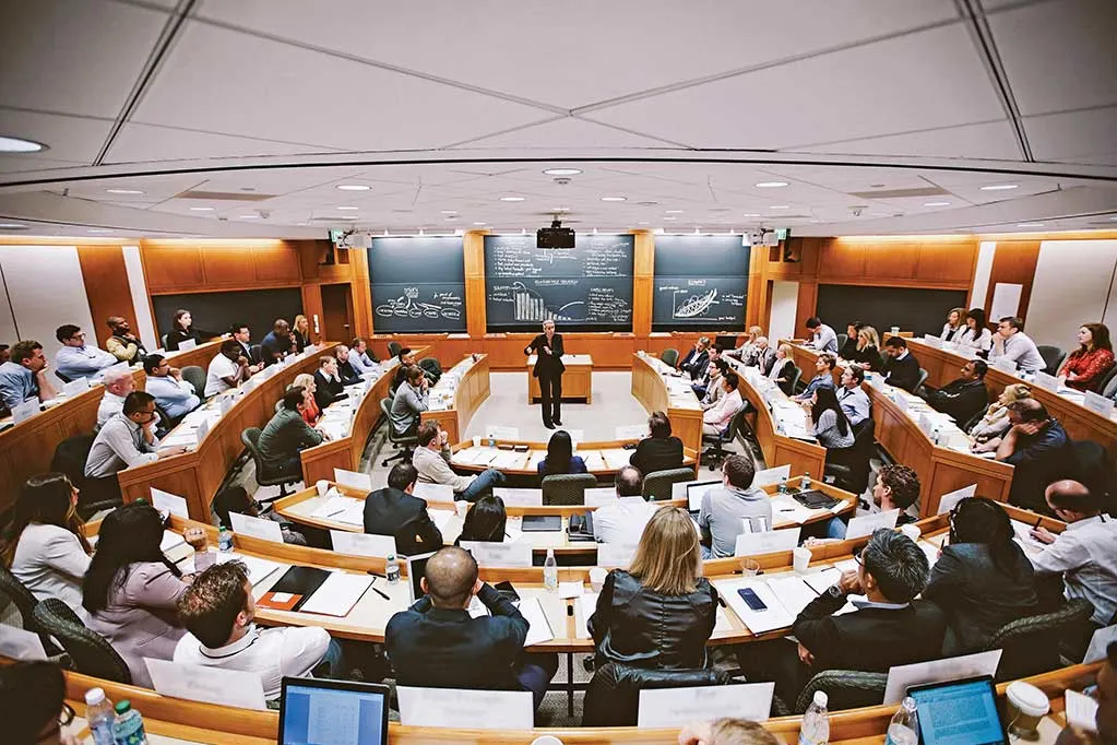 View from the back of a full HBS classroom with a professor Anita Elberse in the center