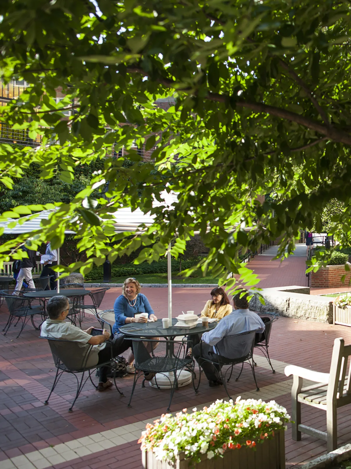 Executive Education participants continue the discussion in the courtyard between Esteves and McArthur Halls.