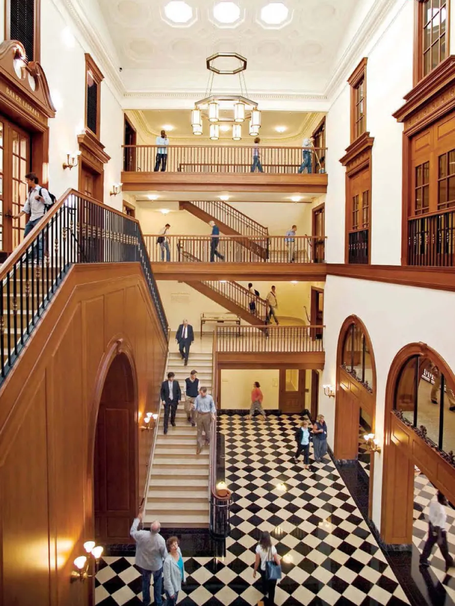 Interior shot of inside Baker Library hall with students 