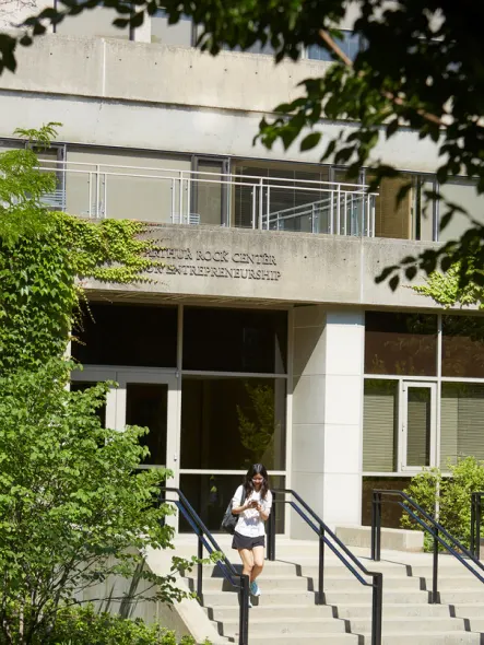 Student walks down the stairs at Arthur Rock Center for Entrepreneurship building front entrance