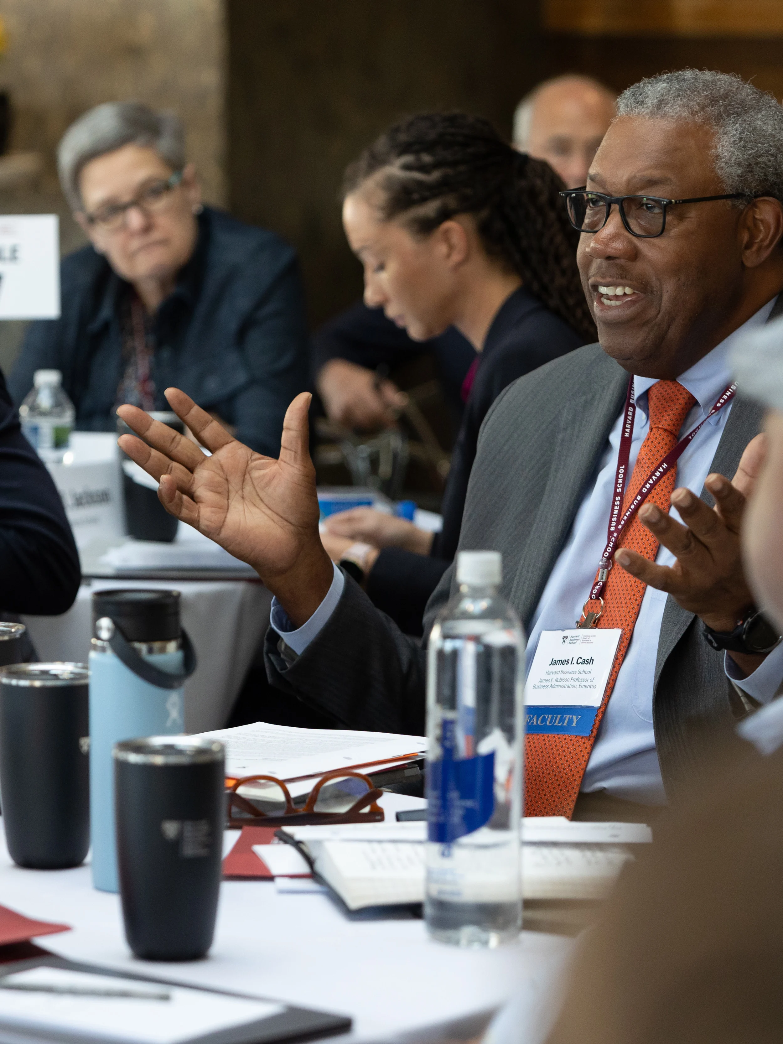 Jim Cash sitting at a table surrounded by people.
