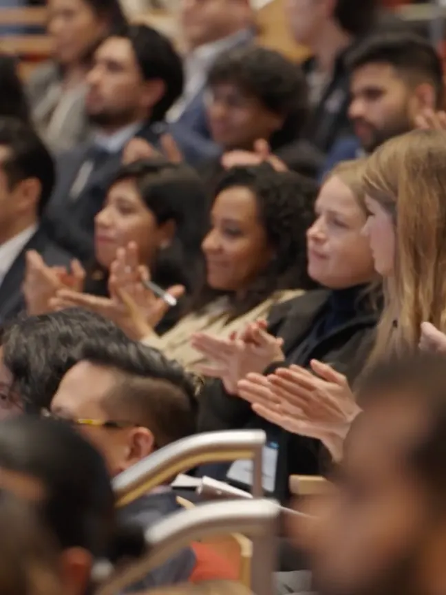 People applauding in auditorium