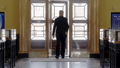 Professor Desai walking through Baker Library on the Harvard Business School campus