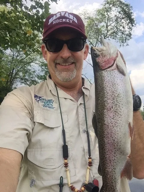 Doug holding a fish he caught