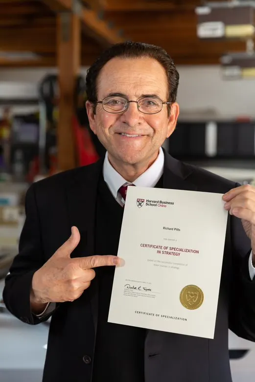 Richard Pitts holding his Certificate of Specialization in Strategy