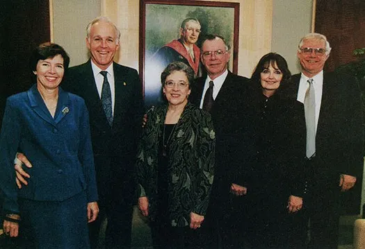 Members of the Teele family in front of a portrait of Stanley F. Teele (MBA 1930), dean from 1955–1962, at the Teele Hall dedication ceremony in 2000.