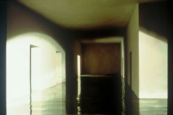 Photograph of a model hallway flooded with water, simulating a submerged interior using poured resin.