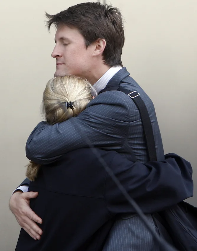 Workers embrace outside the offices of Lehman Brothers in Canary Wharf in London, Monday, September 15, 2008. Courtesy of AP Photo/Kirsty Wigglesworth.