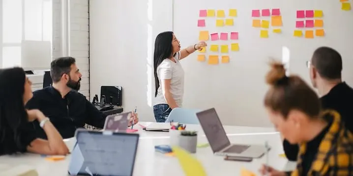 Colleagues brainstorming ideas with Post-it notes.