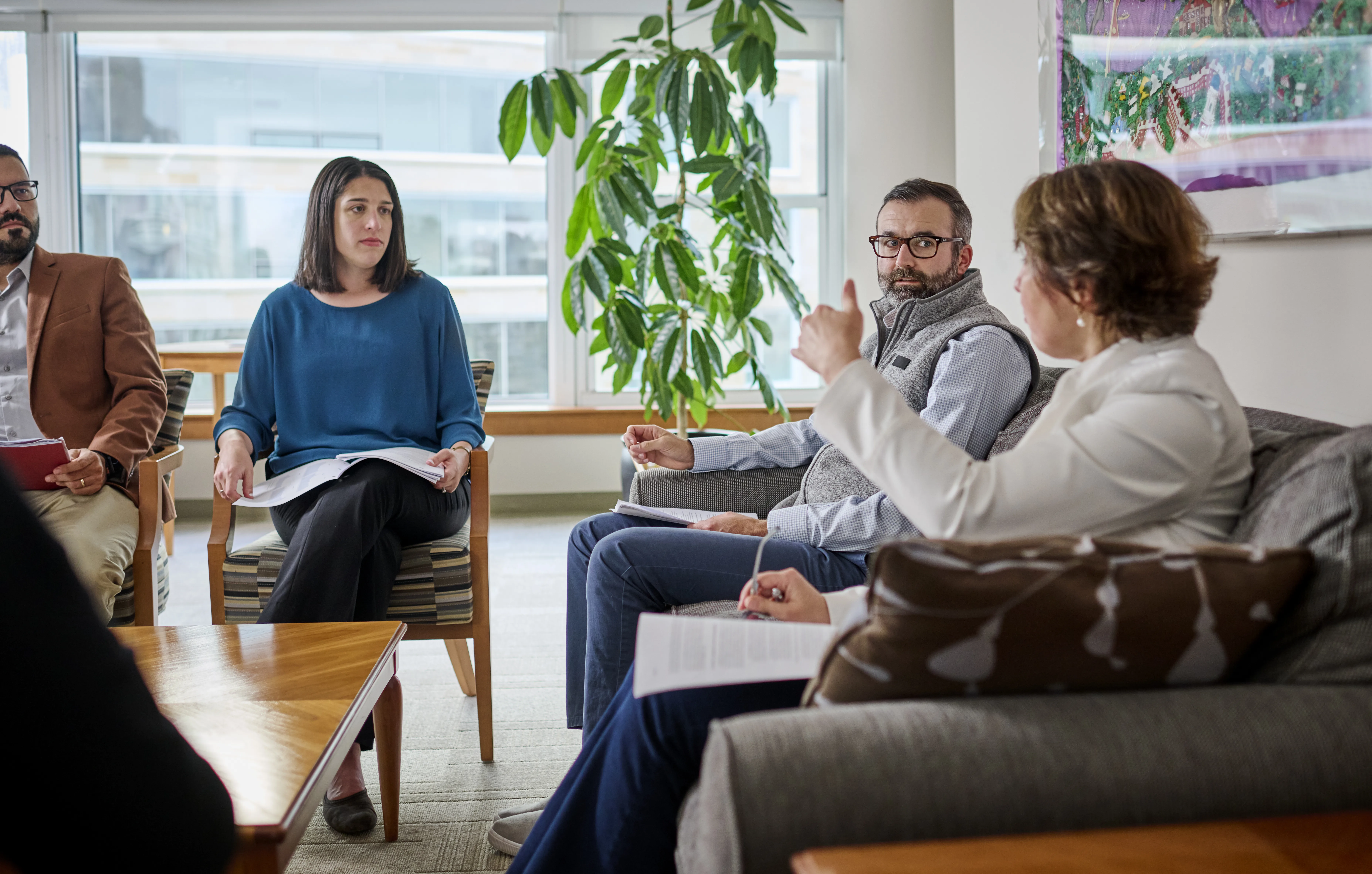 Executives sit and discuss case study.