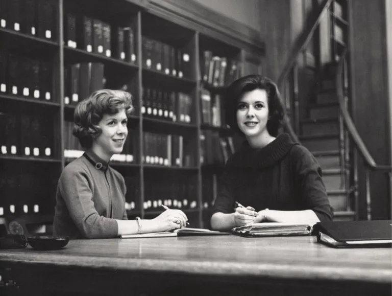 Judy L. Allen (MBA 1963) and Linda T. Ryan (MBA 1963) in Baker Library reading room, ca. 1962-1963