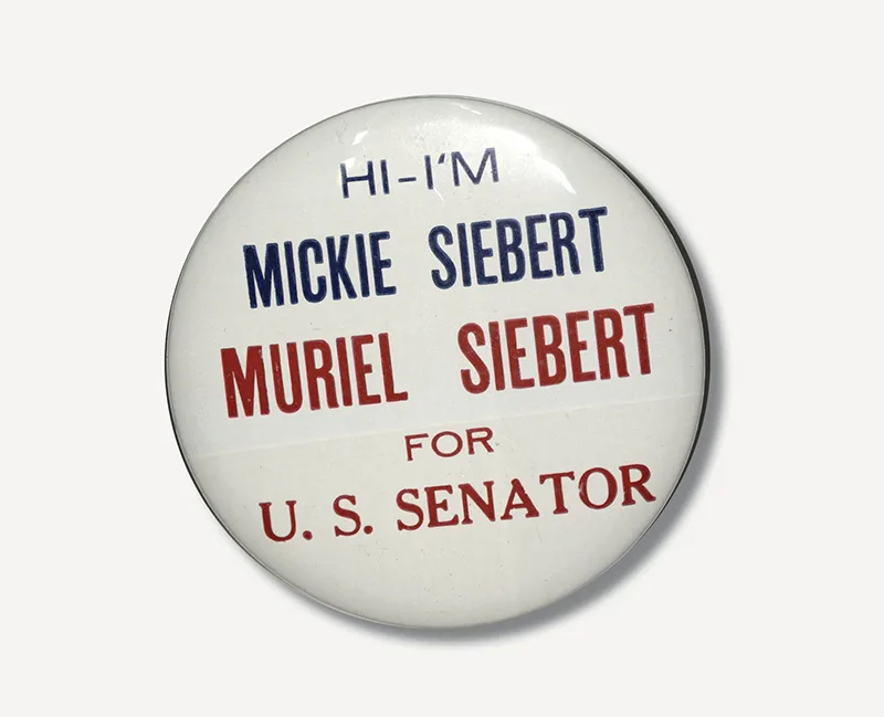 Campaign button reading “Hi—I’m Mickie Siebert, Muriel Siebert for U.S. Senator” in red and blue text.