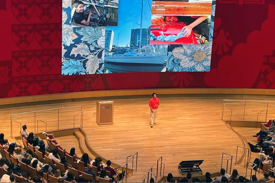 A person giving a presentation on Klarman Hall stage