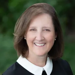 Woman smiling on green background