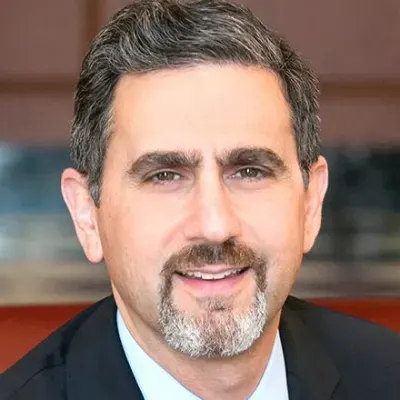 Person smiling with a black suit