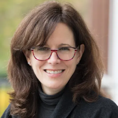 Woman in red glasses and black shirt
