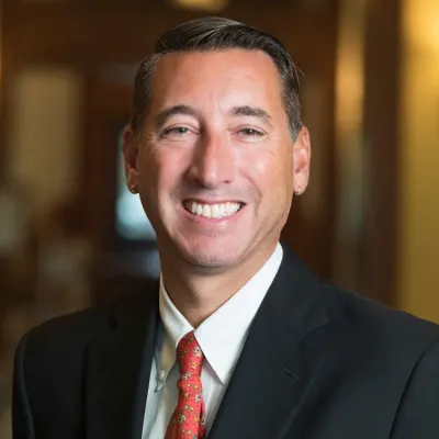Ken Peterson headshot in suit smiling