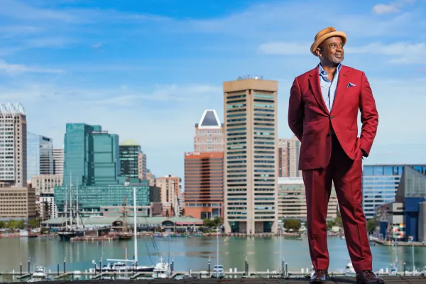 Troy LeMaile-Stovall (MBA 1994) in front of Baltimore skyline