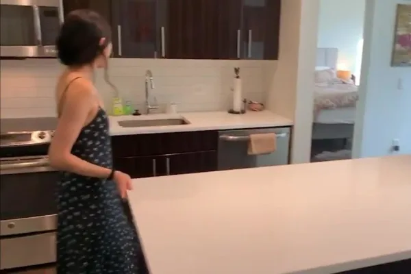 woman walking in kitchen apartment