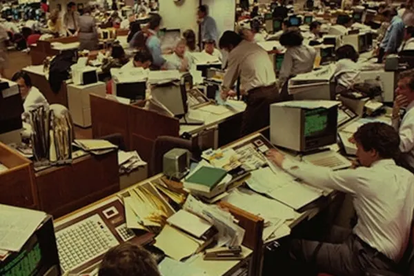 A cluttered and bustling investment banking office