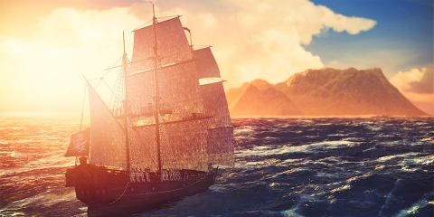 schooner on the ocean with clouds and bright sunshine in the background