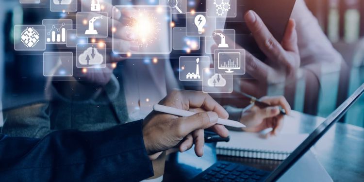 Two business professionals brainstorming ideas with tech-related icons floating