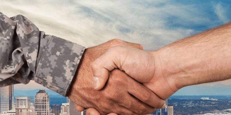 Handshake between military member and business professional
