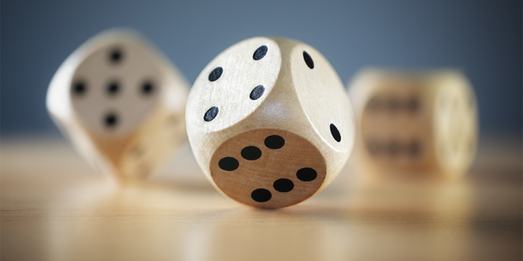 Three Dice Rolling on a Table