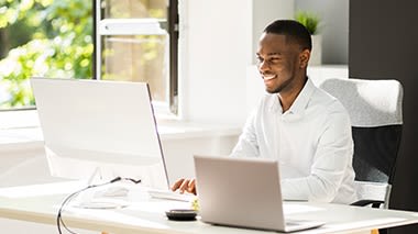 Learner on computer exploring HBS Online business lessons