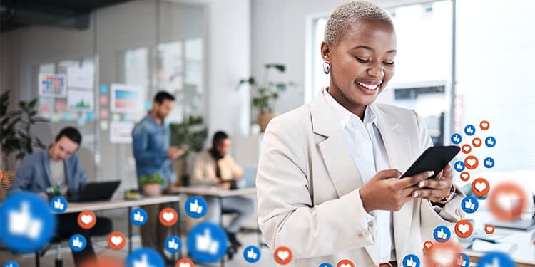 Marketing professional staring at phone with social media icons, including likes, coming out of the phone