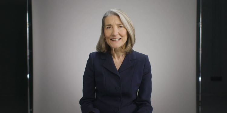 HBS Professor Amy Edmondson seated in front of a white backdrop