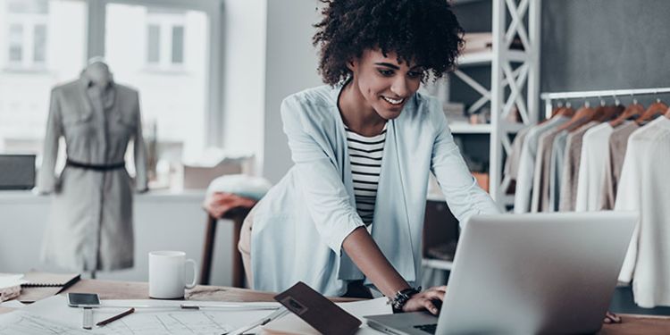 Female entrepreneur using laptop in workspace