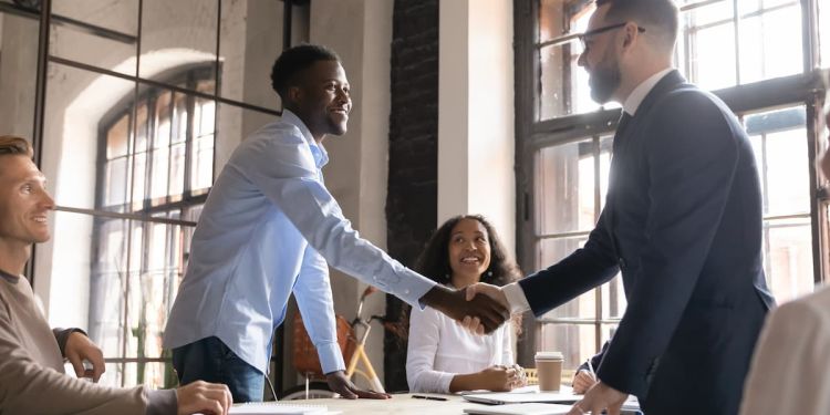 Two business professionals shaking hands during a negotiation