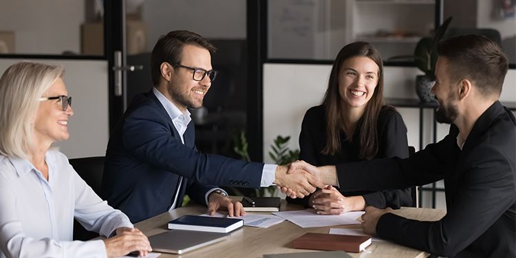 Two corporate professionals shaking hands.