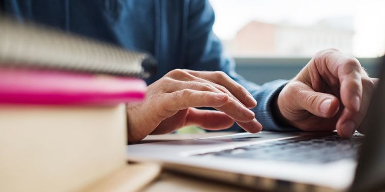 Male Student Taking an Online Course