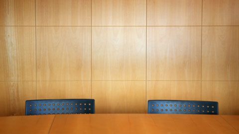 Two chairs at a corporate table
