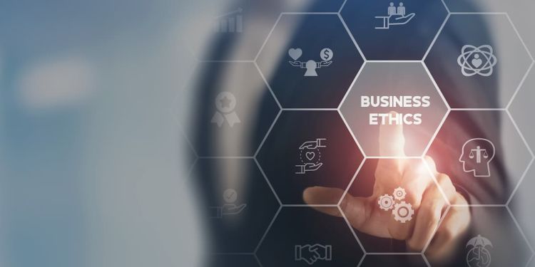 Business professional pressing a graphic that reads "Business Ethics" and is surrounded by icons