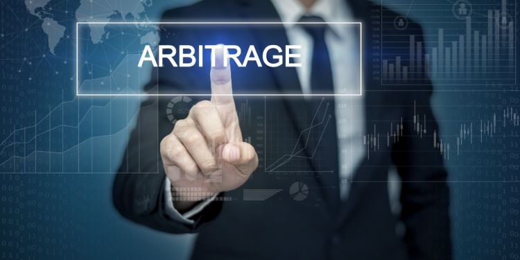 Businessperson tapping the word arbitrage
