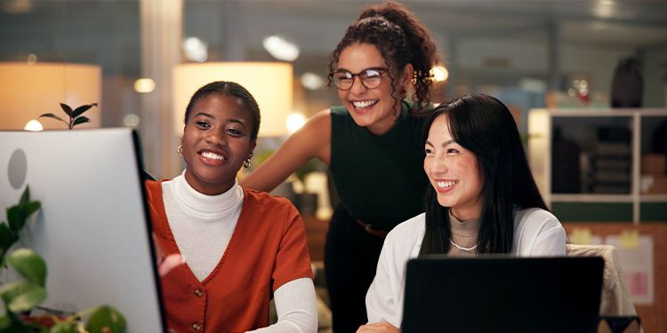 Three team members learning together through an online course.