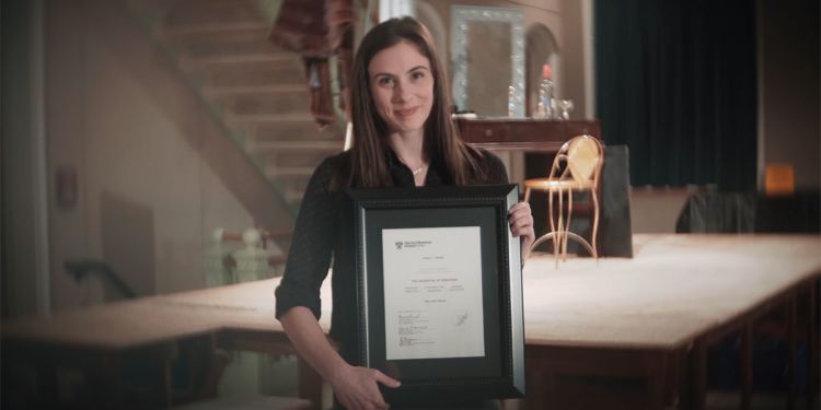Jenna Pollack holding her HBS Online certificate