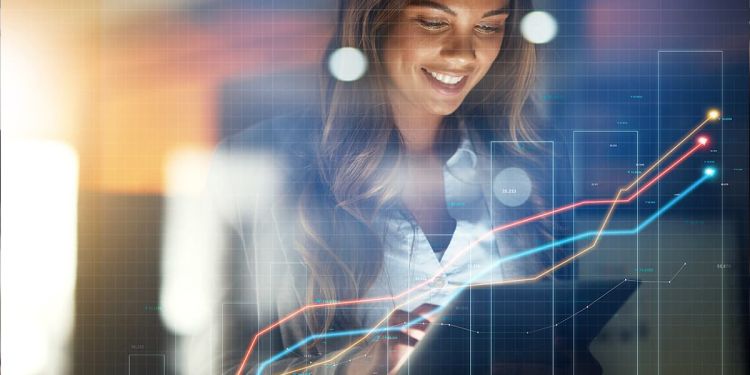 Woman finance professional reviewing finance graphs and performance on a tablet