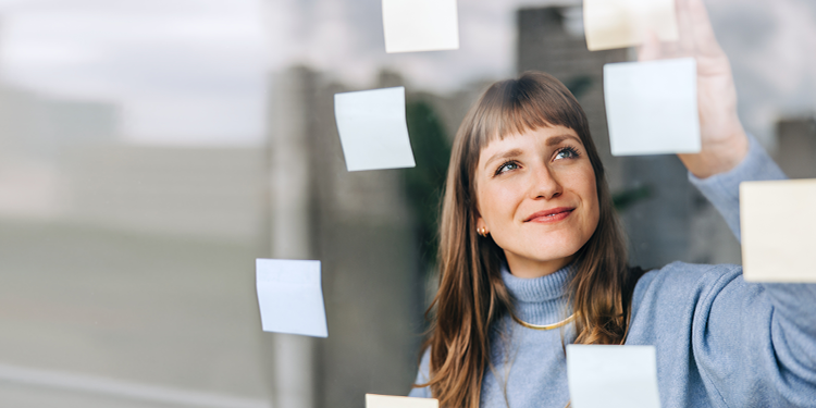 Entrepreneurial marketer brainstorming with sticky notes.