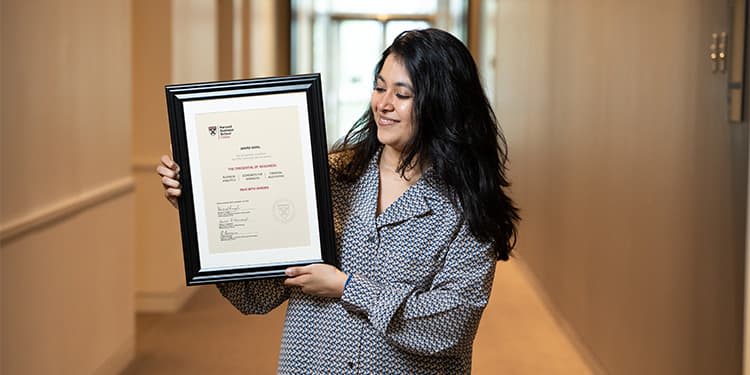 Janavi Gohil holding her HBS Online Credential of Readiness