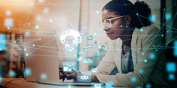 Business professional learning AI on laptop with AI-related icons circling her