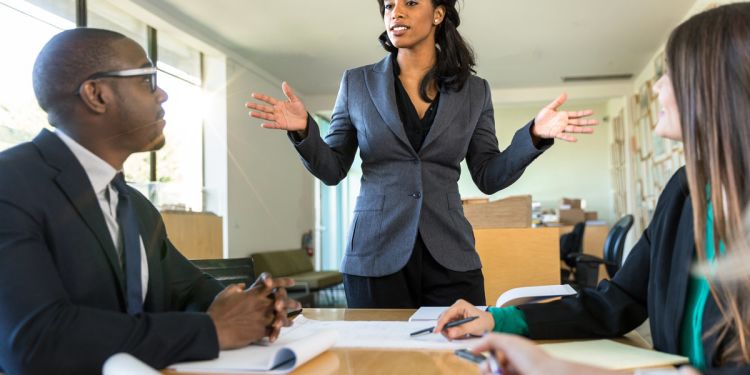 Resilient leader speaking to employees during business meeting