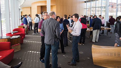 program participants socializing during break in the Tata Hall atrium at Harvard Business School