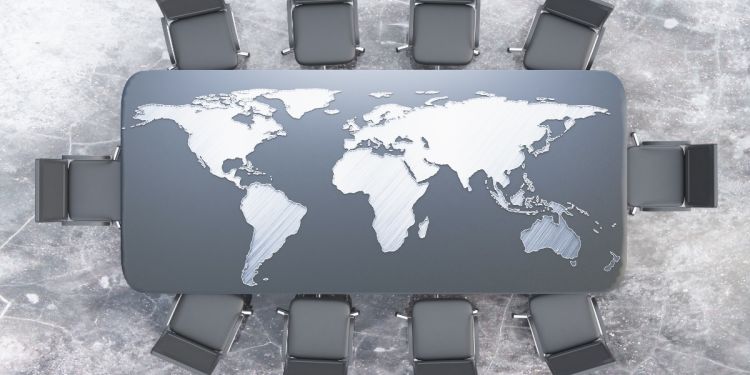 Conference table with a map of the world illustrating global business